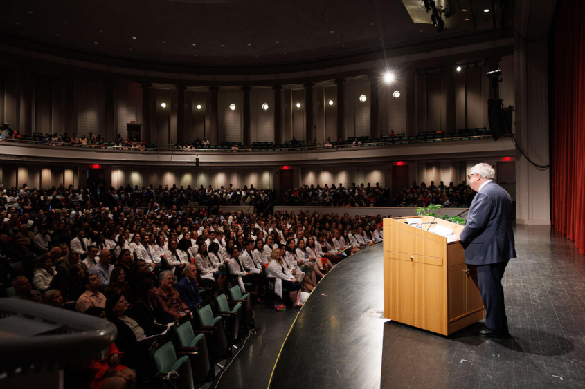 Dean Warnick speaking to audience at a podium
