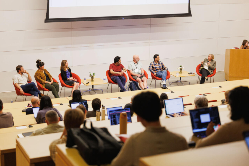 Panelists talking in front of audience