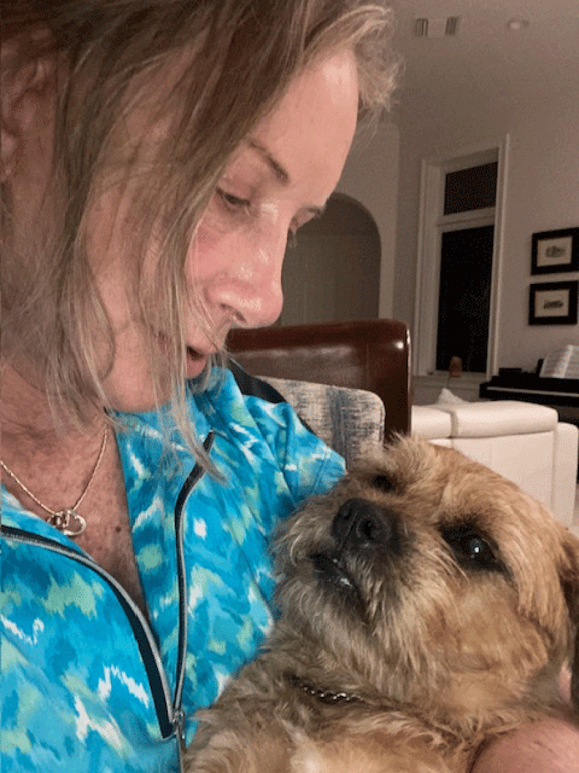 woman holding a small dog