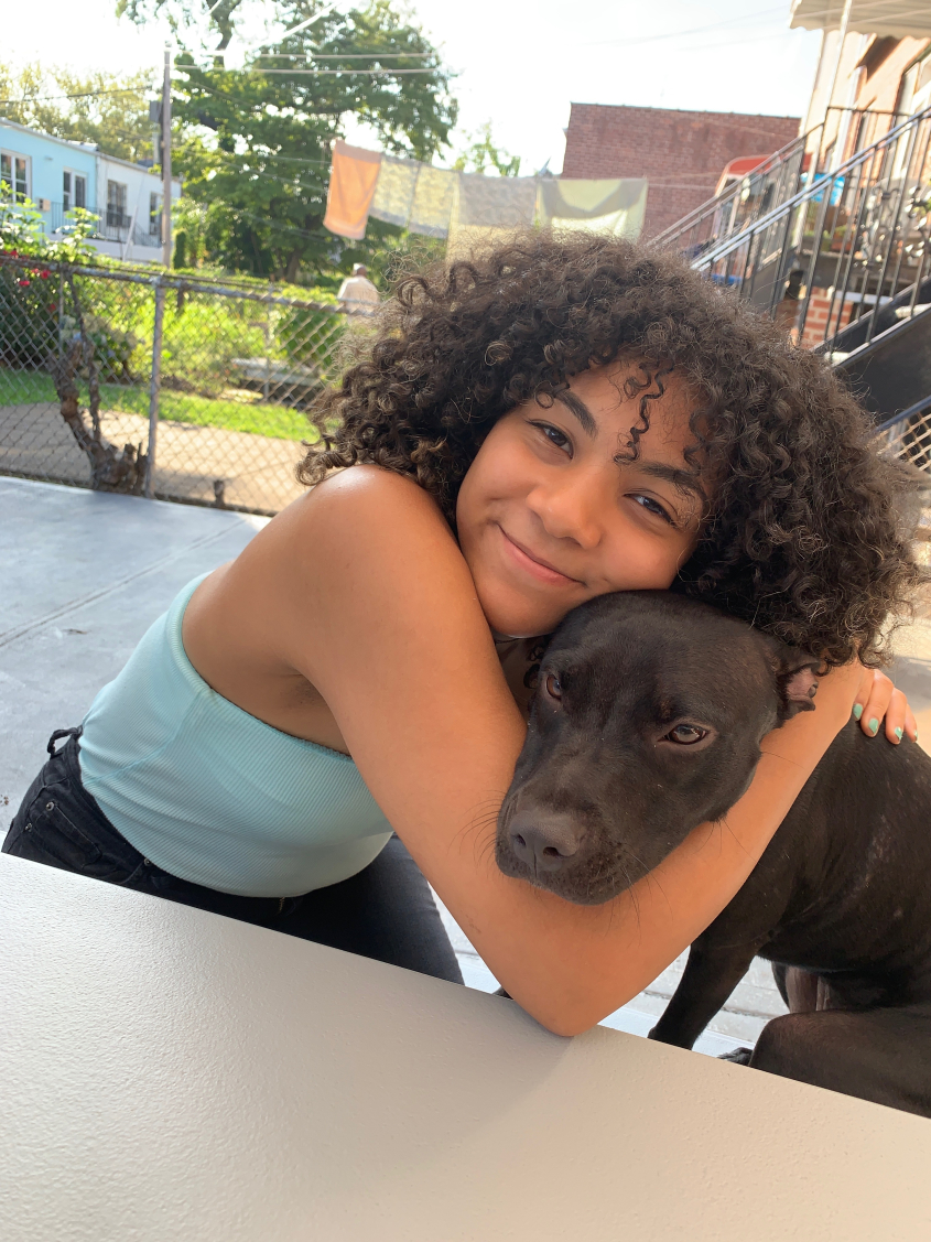 Rose Molina-Gonzalez hugging a dog