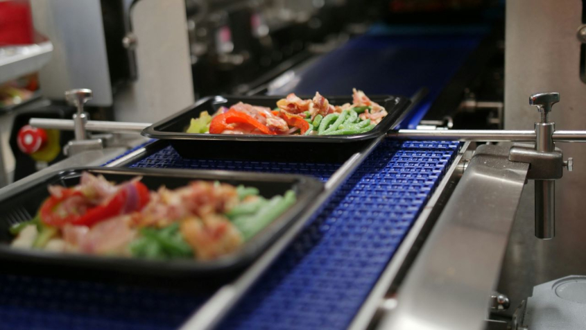 food being prepared on an assembly line