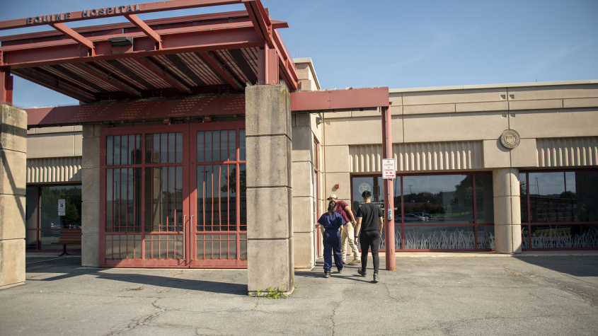Two people walk into the equine hospital entrance