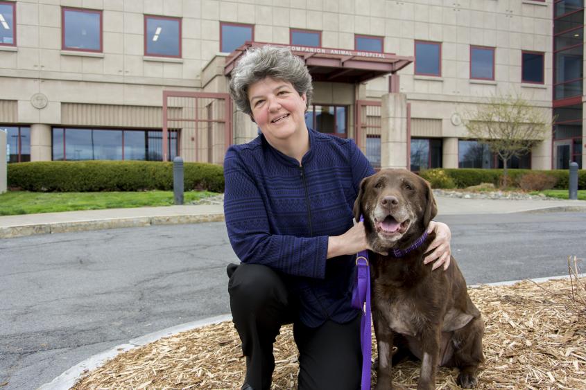 Dr. Meg Thompson poses with her dog outside the Cornell University Hospital for Animals