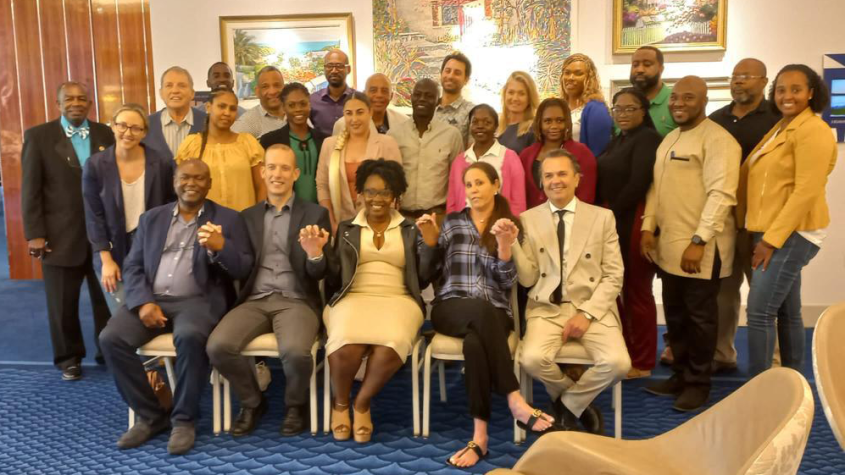 Veterinarians in the Bahamas at a continuing education event, seated and smiling at the camera