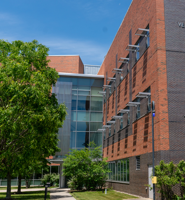 Exterior of the AHDC in summer, with green trees and a blue sky