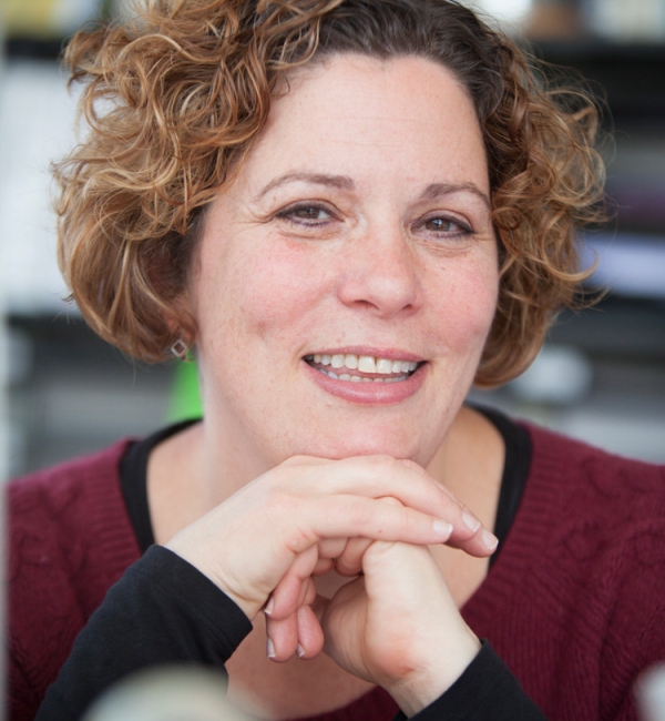 Paula Cohen in dark red shirt with black sleeves