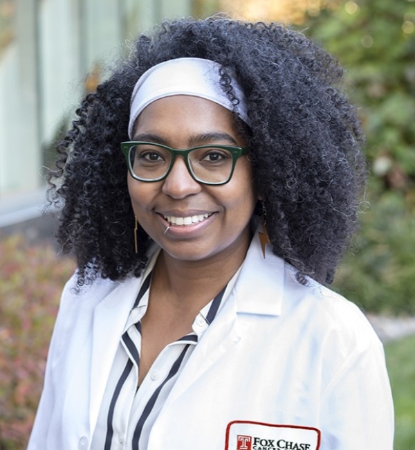 Portrait photograph of Dr. Jaye Gardiner smiling at the camera outdoors.