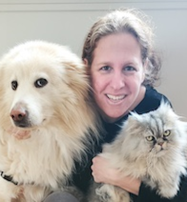 A woman with a dog and cat. 