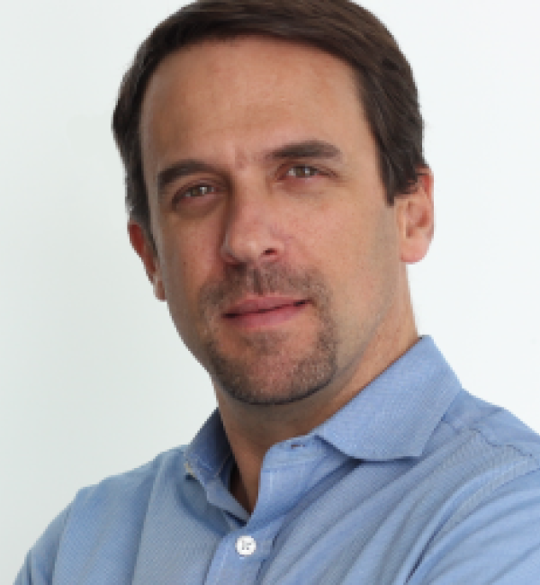 Marcus Smolka wearing a light blue collared shirt.