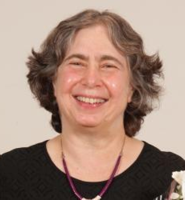 Mariana Wolfner smiling while wearing a black blouse.