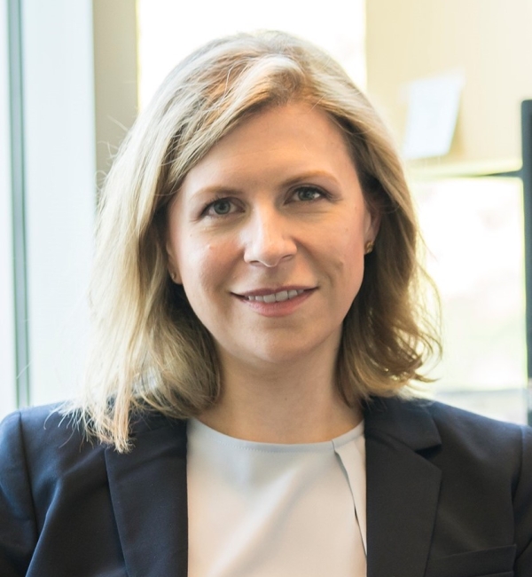 Laura Goodman wearing a black blazer and a white top.