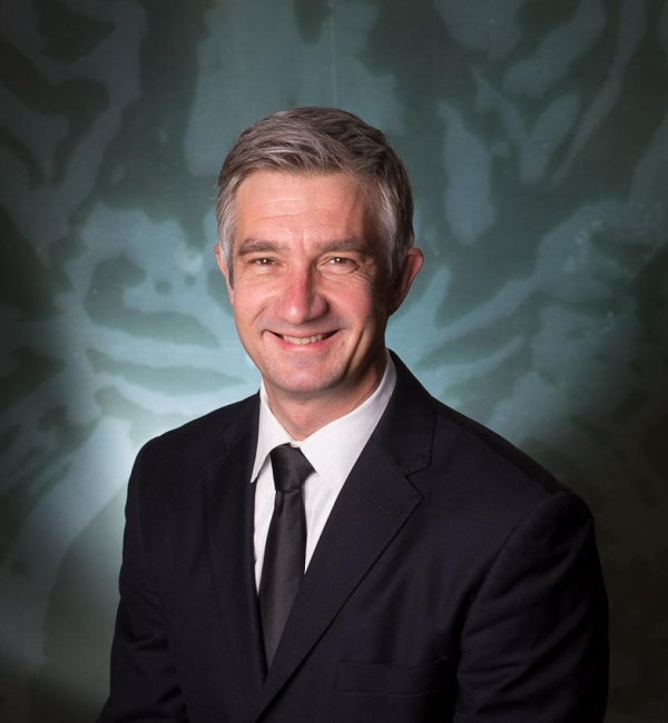 Pierre Comizzoli wearing a suit.