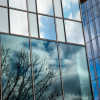 Windows of the CVM research tower reflecting a blue sky