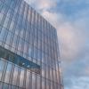 Exterior of Schurman Hall's glass walls against a blue sky