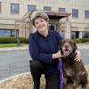 Dr. Meg Thompson poses with her dog outside the Cornell University Hospital for Animals