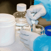 Hands in a lab compounding materials