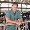 Dr. Rodrigo Bicalho stands near dairy cows