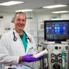 Dr. Jethro Forbes in front of the new extracorporeal blood purification unit at Cornell