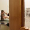 Focus on the Cornell seal on a door to an exam room at CUVS