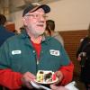 Willis eating cake at his celebration with colleagues and friends