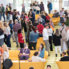 A crowd of conference attendees mingling in the CVM atrium