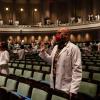 Veterinary students in white coats take the Veterinarian's Oath in Bailey Hall