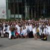 The DVM Class of 2023 poses outdoors with their white coats