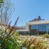 The interior courtyard of Cornell Vet, with flowers in the foreground and a glass building behind them