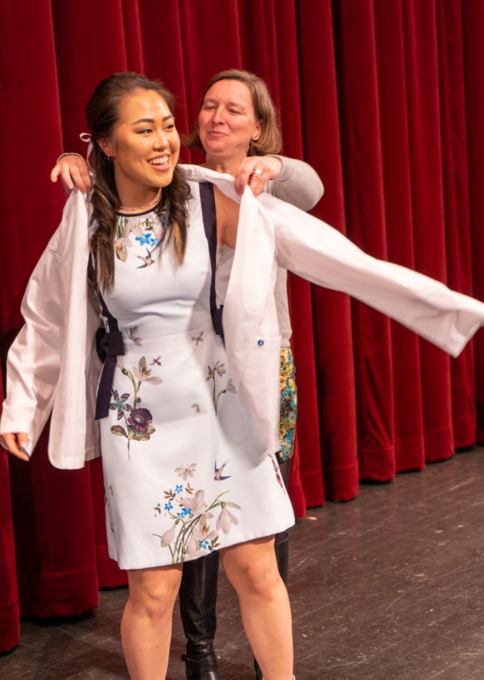 a DVM student gets coated at the white coat ceremony